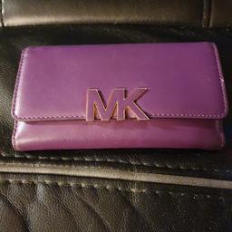 Lovely Michael kors purple purse,unusual but also an eye catcher,has lots compliments,has loads sections for cards notes and more. Coin section under the big MK badge
