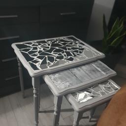 upcycled nest of tables, painted with fenchic chalk paint. Top grout could do with some tlc/touching up. Tried to show in last pic but not very clear. Definitely one offs and get attention. Paper under middle table with a glass top and can be changed to suit your decor. Also stack nicely together