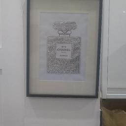 Chanel No5 Print in Black Frame. Excellent Condition. Would look Lovely in any room. Collection only place. Black Frame, White & Silver & Black. Sparkly