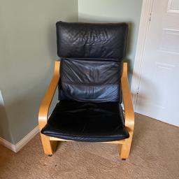 Leather rocking lounge chair with wooden arms.