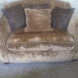 Velvet Gold Colour Cuddle Chair. Extremely Comfortable. Very Heavy. Would need two people to move. Collection Only Please. Need The Space. Massive Reduction on Price.