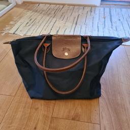 Blue Longchamp bag. Had this for quite a few years so in need of some TLC. Stitching starting to come undone, and scuffs on edges, but zip and clasps work fine. 

Thanks.