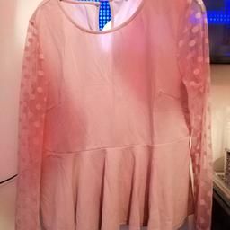 Ladies dusky pink top. Size 2xl.Has see through sleeves with dot effect. Has key hole at the back with a pleated floating edge.