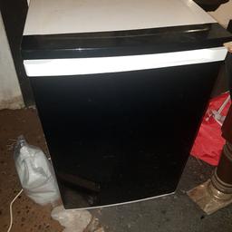 wrapped the front black but can be peeled off. the freezer door comes off because the hinge is broken. never used the freezer so unsure of efficiency.  fridge works well. free for collection.