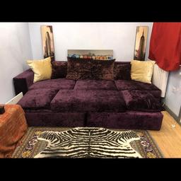 Had to realist due to time waster/  scammers This is a large purple crushed velvet sofa with matching cushions and a large stool/ seer which can be arranged as a L shaped sofa. It has only been used in the cinema room a hand full of times hence it is in a immaculate condition as new. This was not cheap as it was custom made to last. In fact it cost £ 3000. So a real bargain at £550. I also have a purple chaise which you can have.the size approximately 3.4 meters wide and 1.3 meters deep.