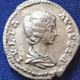 Julia Domna Genuine Silver Denarius bust facing right reverse Felicitas Isis Wearing Polos Standing Right Resting Left Foot On Prow Holding Infant Horus At Breast Patera Rudder Leaning Against Altar Behind .clipped at on end 3.3 grams 18mm .