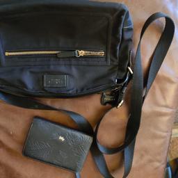here is my Radley bag and purse in good used condition.the bag is nylon, suitable for crossbody has inside and outside pockets and the dog hanging charm who's lead is a bit frayed. the purse is leather and will hold coins and cards