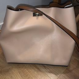 Pale pink and white handbag with brown adjustable strap. Inside has a zipped pocket in the middle. Used twice!
