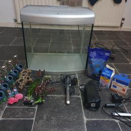 Complete set up. 65 litre Aqua One fish tank. Fitted bulbs need replacing but an additional Ciano led light is included. Also comes with Fluval filter plus new sponge in box, Interpet heater, new 2kg bag of gravel (black and white), aquarium salt, 6 large ornaments, 6 small ornaments and 2 plants. Asking £60 but open to offers.