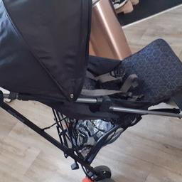 Black mother care pram with hud and raincover swivel wheels in good condition