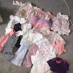 Baby girls clothes includes......... 8 baby vests, 6 tops, 5 trousers, 6 baby grows and a pair of pj’s  and a pink hat all from first size to 0-3  27 items in total