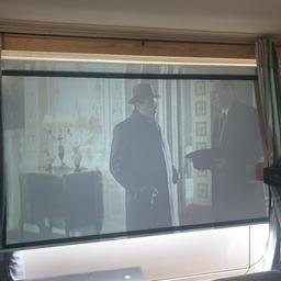 projector and screen with electric ip and down 8 foot long very good condition