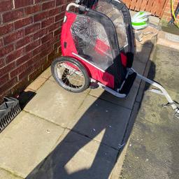 Child’s single bike trailer . Hardness and rain cover included brilliant condition only used twice its attaches onto any bike using the nut shown I bought this from halfords
