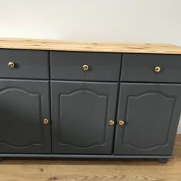 A lovely solid wood, stylish sideboard. Colour: meridian grey with a natural wooden top which has been sanded and waxed. 
Lots of storage consisting of drawers and 3 cupboards with shelving inside. Can deliver locally 

Size: 
Lenght 123cm
Height: 79cm 
Depth : 34cm