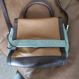 here is my very unusual radley crossbody bag in very good condition it has an adjustable strap and can be handheld as well. inside are a zipped and open pocket. and an outside pocket under the flap which is magnetic fastening. it has the dog charm and I can post.