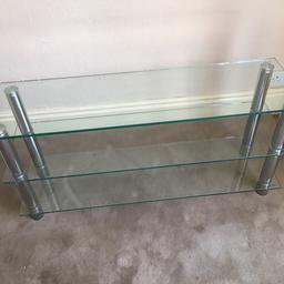 Clear Glass and silver metal tv stand , good quality heavy plate glass with silver metal legs in very good sound condition from a smoke free home.