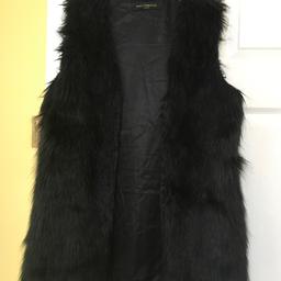 Black faux fur, gillet, size 10/12. ( no size label in it) 
Like new.