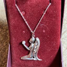 Vintage Sterling silver necklace of an angel holding a Pearl fully hallmark measures just over 1 inch with an 18 inch chain