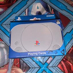 Playstation playing cards in PSX PlayStation tin.

New unopened