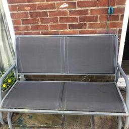 Grey metal swinging garden bench in perfect working order. Rusting around the screws but other than that it’s great