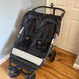 In used condition, double buggy that can fit through a standard doorway! We purchased the puncture proof wheels and comes with rain over. Few minor scuffs to frame and slight rip in side of fabric, which is reflected in price. Comes with raincover. Can deliver locally or collection