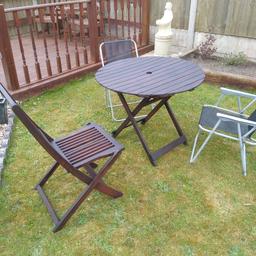 Hardwood  folding garden table and 3 chairs. one hardwood chair and 2 metal chairs.