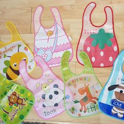 7 brand new baby/toddler feeding bibs with velcro fastening. All are wipeable.