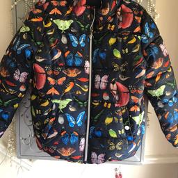 Navy blue coat with butterflies thick quilted in good condition from H& M but missing the hood age 8-9 years £3 collection Elm Park