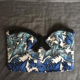 Strapless stretch crop top by Topshop in different shades of blue with bra style fastening at the back.
States size 10 on label but fits more like an 8.
Worn once or twice but still in great condition.