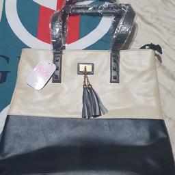 brand new hand bag never been used with the tags still on unwanted gift cream and black leather