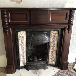 Antique Cast Iron Fireplace with original tiles and front cast iron grate with fire basket. 

Fire surround and separate top mirror section

Width = 137 cm 
Height = 123 cm 
with mirror height = 218cm