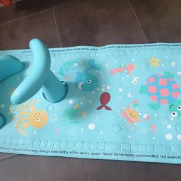 Non slip bath mat with seat for babies to sit in.