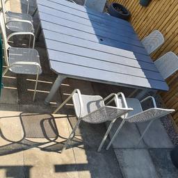 large garden table custom made all wooden construction 1.8m x 1.7m anthracite grey in colour complete with 8 metal carver chairs in grey reduced patio size very heavy need 2 people to lift legs remove for transport collection whittlesey