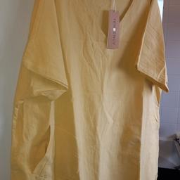 New dress with tags 100% cotten linen mustard yellow with 2 pockets. lovely  dress but far to big for me ordered from airy clothes but was to late to send back very roomy size 18..20 plus well come to take a look at any of my items..