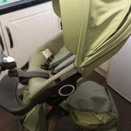 stokke xplory pram system in green comes with everything you need, carry cot, raincovers, cosy toes, bags ect collection only, cash on collection.