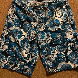 Summer swimming shorts by SMITH AND JONES. Size small Waist 30inches
Length 21 inches in aqua blue white floral design. Drawstring fastening. Very good used condition. Collect Flixton.