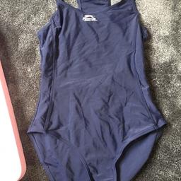 A Slazenger swimming costume and a pairs of pink Speedo Junior goggles. In good condition from a clean and smoke free home.