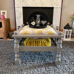 This is an attractive, square, upcycled coffee table / footstool. The wooden frame has been finished in Fairfield grey and the cushioned middle has been upholstered in Dalmany Sunflower fabric by Ashley Wilde, to compliment it. As you can see, there’s a shelf below that can provide storage for magazines, books, throws etc. Height 53cm, width 71cm and depth 71cm approx. Collection from Dunsville, Doncaster or can deliver within Doncaster area for a fee.