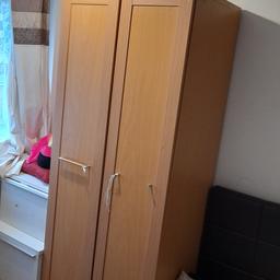 oak effect wardrobe, one handle missing, still good usable condition. hanging rail with shelf at the top.