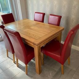 Absolutely beautiful dining table with 6 red leather roll top chairs. Many a happy memory made at this 😁 it’s been very well cared for, slight mark to the top as seen in photos but this can easily be removed with a light sand and re wax. One chair has signs of use (the one used the most!) the extending ends come out easily.
Height: 80cm
Width: 90cm
Length: 140cm
Extended fully: 220cm
(Each extension piece is 40cm)

The legs can be removed for ease of transportation. Please note this is SOLID oak