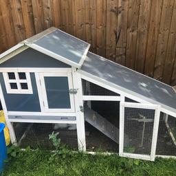 Double story rabbit hutch with run does have some bite marks other that still in excellent condition not even a year old comes with protective thermal cover 