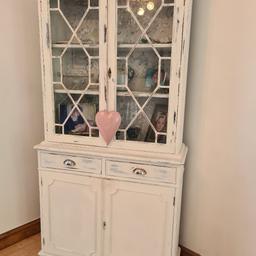 Shabby Chic Wall Dresser Cream White in colour, wallpaper with grey floral design shelf area 2 drawers and 2 large cupboard style storage on the bottom, glass doors.