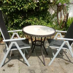 Lovely garden table and 2 chairs. The chairs are in fab condition and the table is excellent no marks on the glass or chips