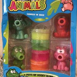Brand new slime squirting animals 
Never opened 

4 pots of slime
4 animals
