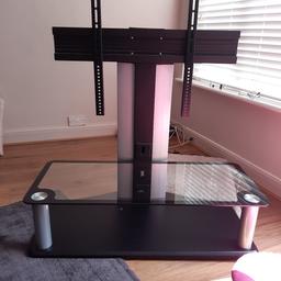 elevated tv stand to hold flat screen TV with glass base shelf.