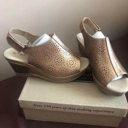 Sling back wedge sandal..made by cushion walk.very comfortable.like walking on air.Velcro back strap for extra comfort.new in box.bronze colour.size 7.