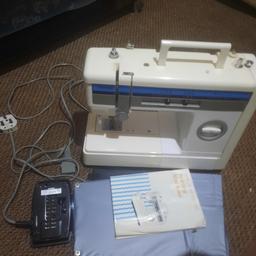 sewing machine with instructions and foot pedal