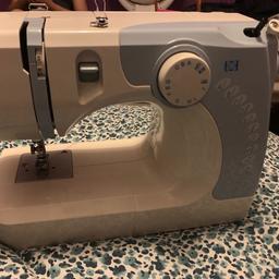 This sewing machine is cream and light blue. Works perfectly fine has no problems to it.