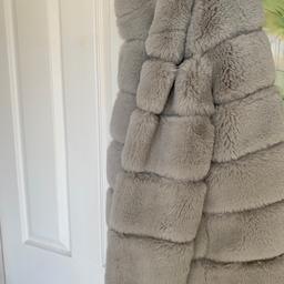 Beautiful quality hooded grey panelled faux fur coat. Immaculate condition never worn. Great for autumn/ winter coming up. Collection or happy to post at buyers expense.