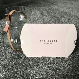 100% genuine Ted Baker rose gold leather bracelet. Immaculate condition, hardly worn. Comes with original box. Rose gold tone with crystal in the centre with Ted Baker branding on either end. Fully adjustable Rose gold leather strap to fit most wrist sizes. I can post.